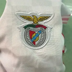 High-quality SL Benfica club crest on white fabric using professional Custom Soccer Jersey Embroidery.