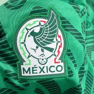 Modern Mexico national team eagle crest on green fabric using Custom Soccer Jersey Embroidery.